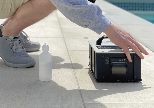 man-using-tribometer-next-to-pool