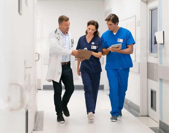 three-doctors-walking-in-hospital-corridor